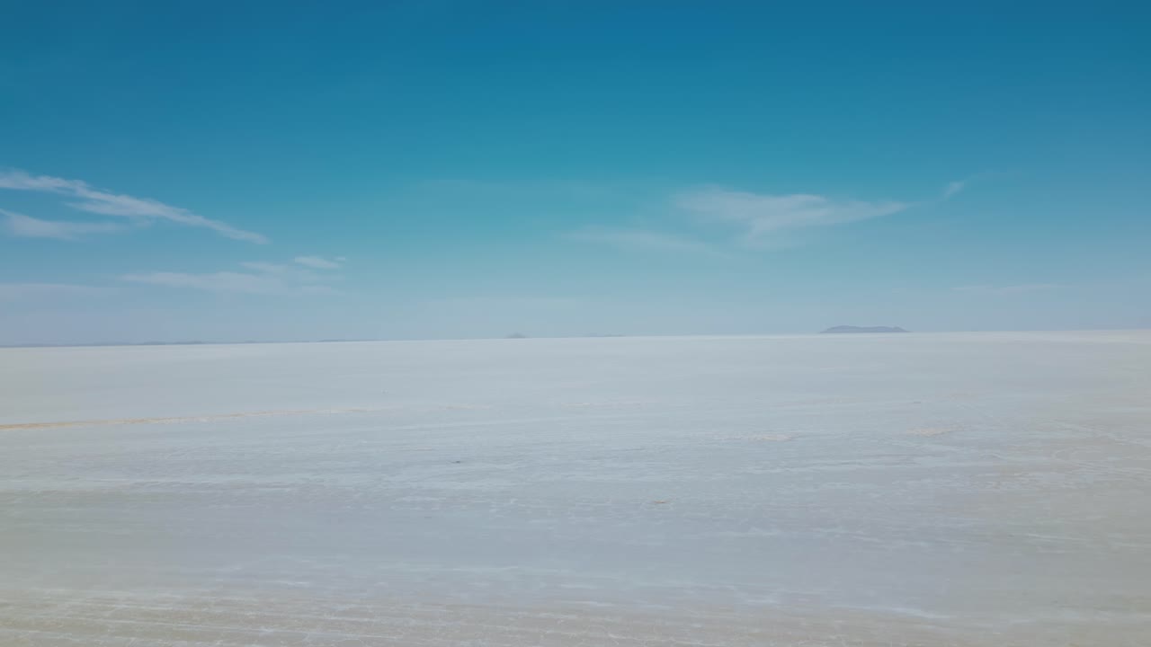 Discover the enchanting allure of Bolivia's Salar de Uyuni with breathtaking drone footage showcasing the endless salt flats from an aerial view