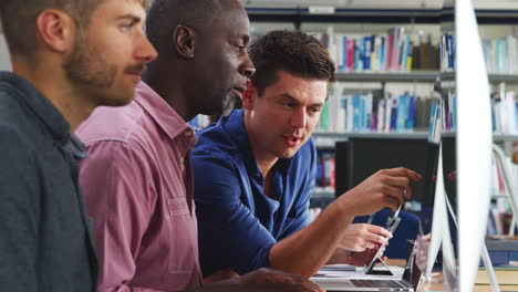mature male student with tutor learning computer skills