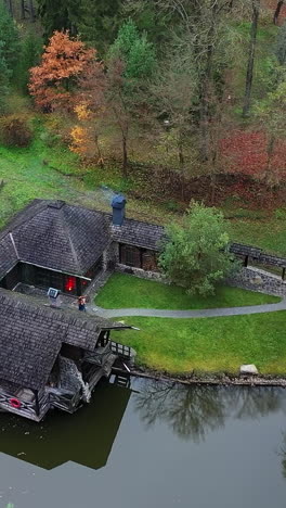 rest of tourists in autumn forest. resting building with pond in beautiful forest area
