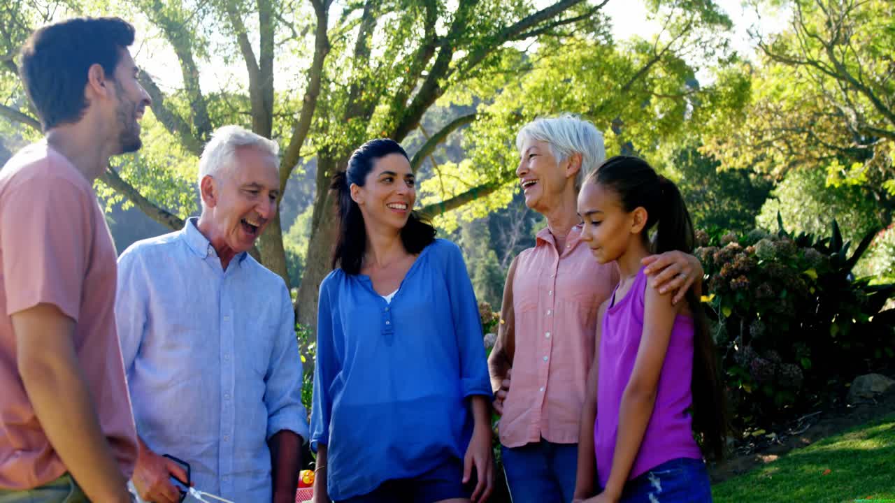 Family standing together in park 4k