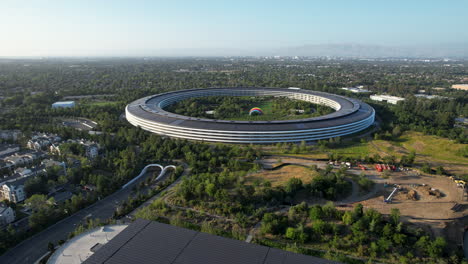 apple park 'spaceship' headquarters in cupertino san jose california with an aerial dolly shot with surrounding landscape views