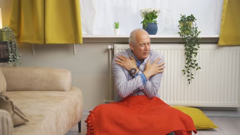 The-old-man-leaning-on-the-heater-is-cold.