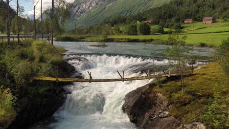 Suspension-bridge-over-the-mountain-river,-Norway.