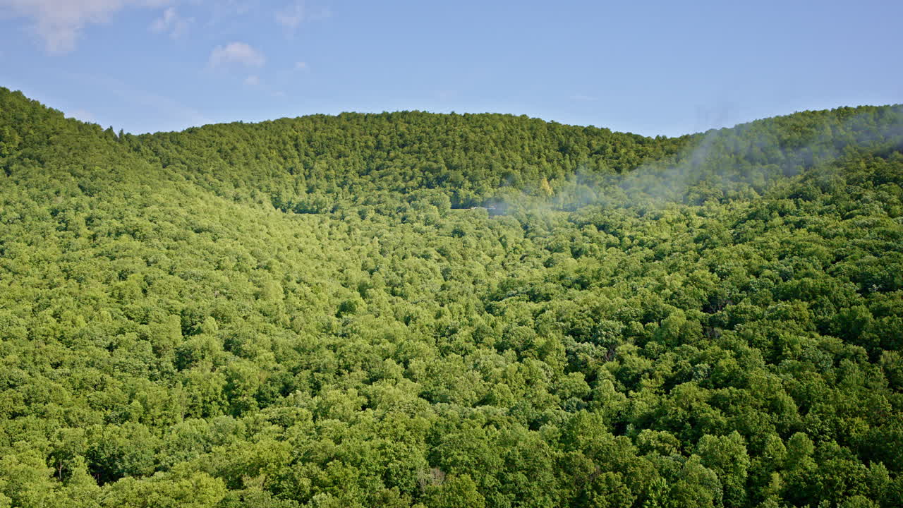 Aerial sweep over mist drifting between Smoky Mountain peaks