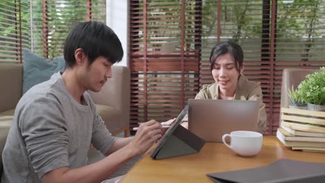 home finance,husband and wife discussing paper bill receipt from tablet laptop together on the floor at living room with focus and concentrate feeling with about family debt home interior background