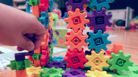 hand spinning colorful kids gears, close up