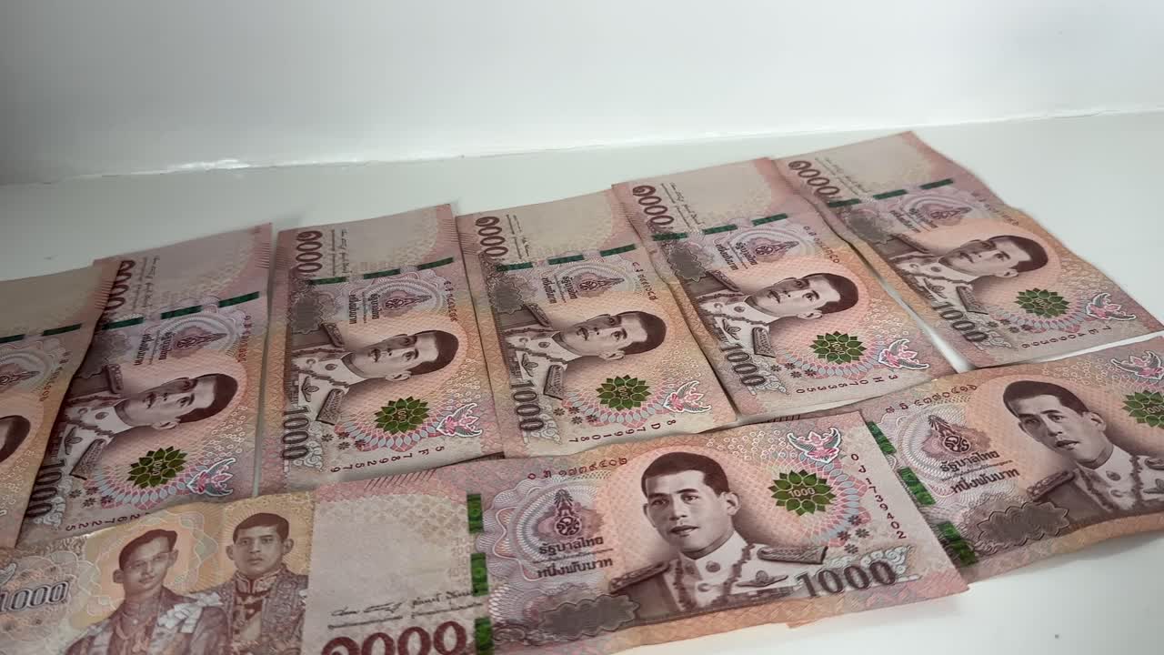 Close up shot of Thai baht Thailand cash currency THB bills and bank notes money economy
