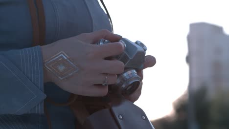 woman holding a vintage camera