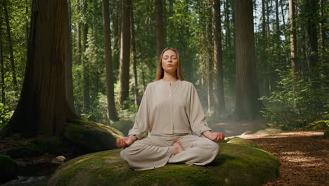 woman meditating peacefully in a tranquil forest
