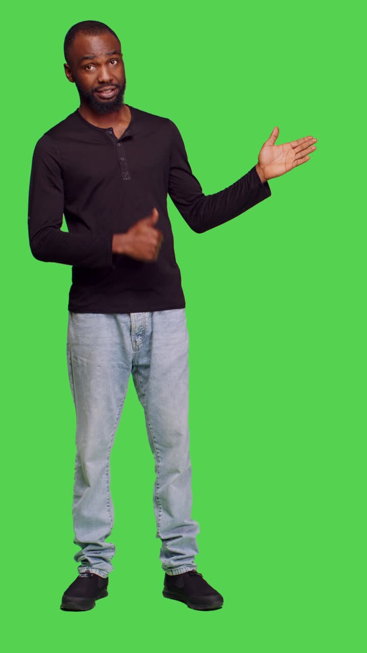 Vertical video: Front view of african american man creating advertisement in studio