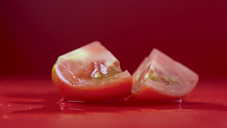 sliced tomato on red background