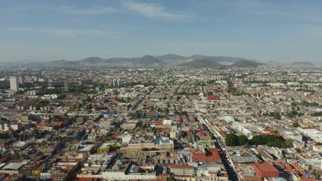 mexico city seen from above with mountains in background on beautiful day