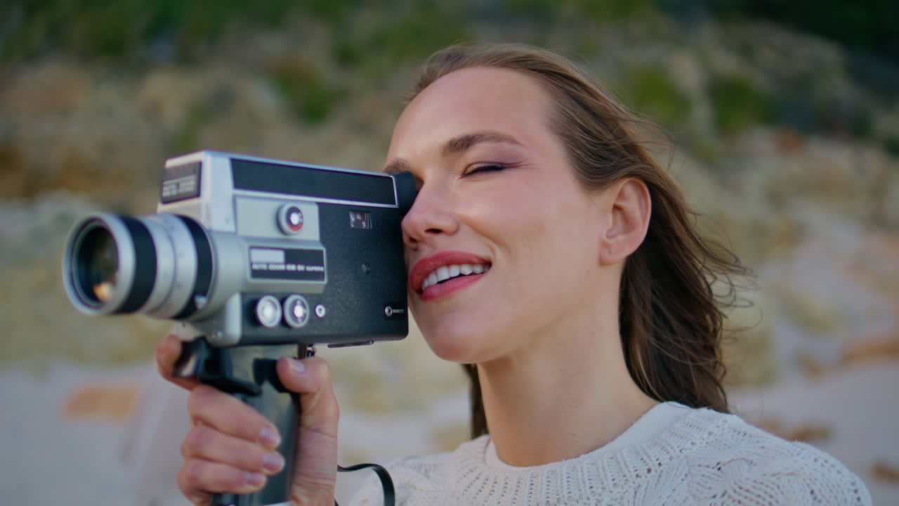 Woman tourist recording landscape on vintage videocamera closeup. Portrait lady