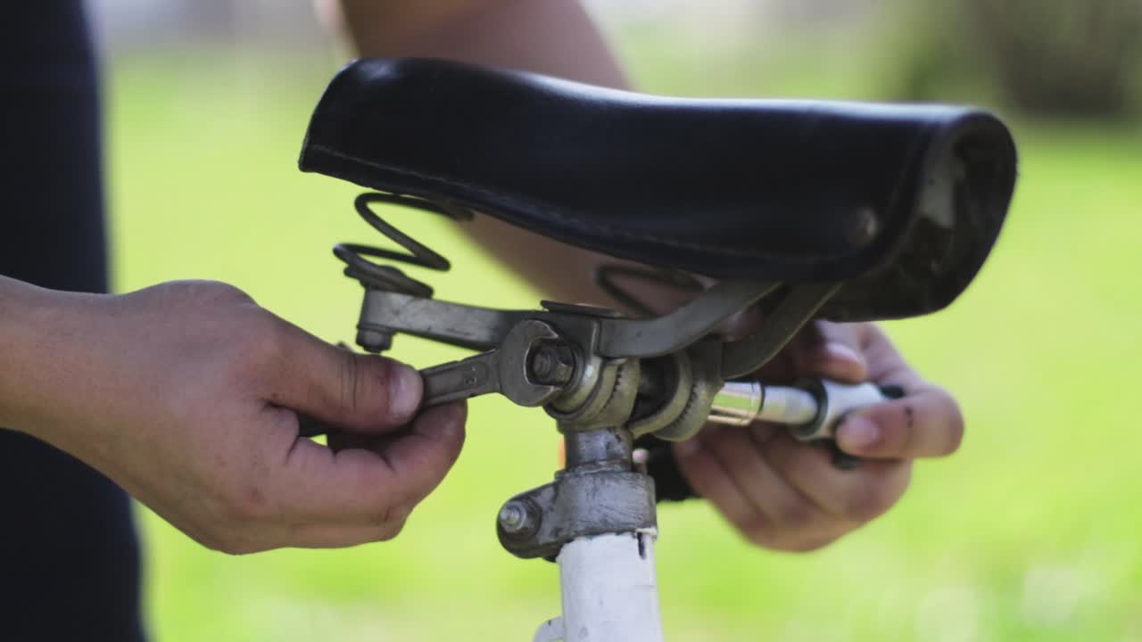 Fixing a bicycle seat with a wrench and a ratchet. Bicycle industry. Bike repair.