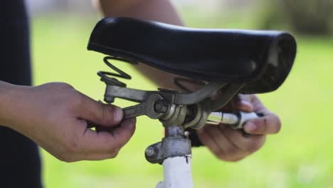 fixing a bicycle seat with a wrench and a ratchet. bicycle industry. bike repair.