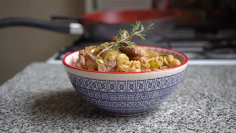 smoking bowl of pasta with meat pieces