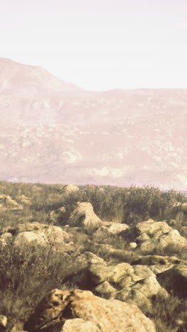nature landscape featuring rocky terrain and distant mountains during daylight