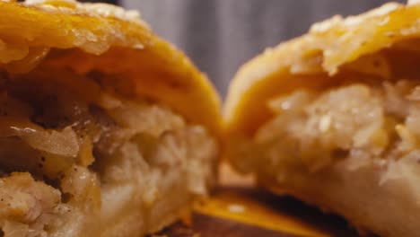 close-up of a sliced savory pastry filled with potato and onion