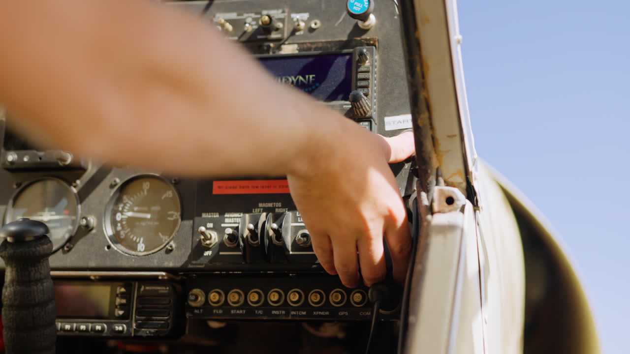 Pilot's Hand Operating Switches on Airplane Cockpit Instrument Panel