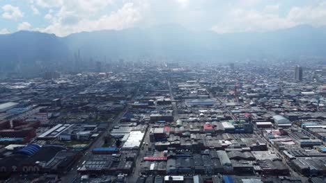 he-buildings-of-the-industrial-zone-stretch-out-in-a-patchwork-of-warehouses-and-factories,-their-roofs-gleaming-under-the-midday-sun