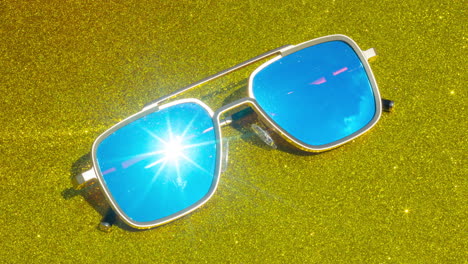 mirrored sunglasses reflecting clouds