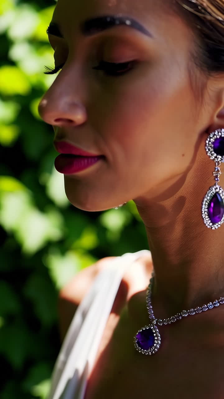 Close-up shots of an elegant woman wearing luxurious purple and silver jewelry against a green background