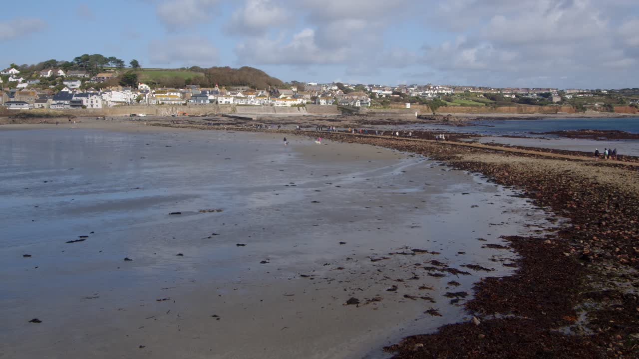 wide shot looking from Saint Michael's mount harbour on to the Causeway with Marazion in background