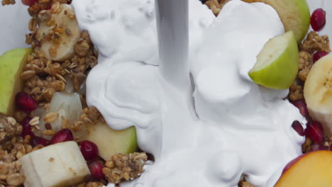 cream pouring fruit muesli in super slow motion close up. healthy lifestyle.