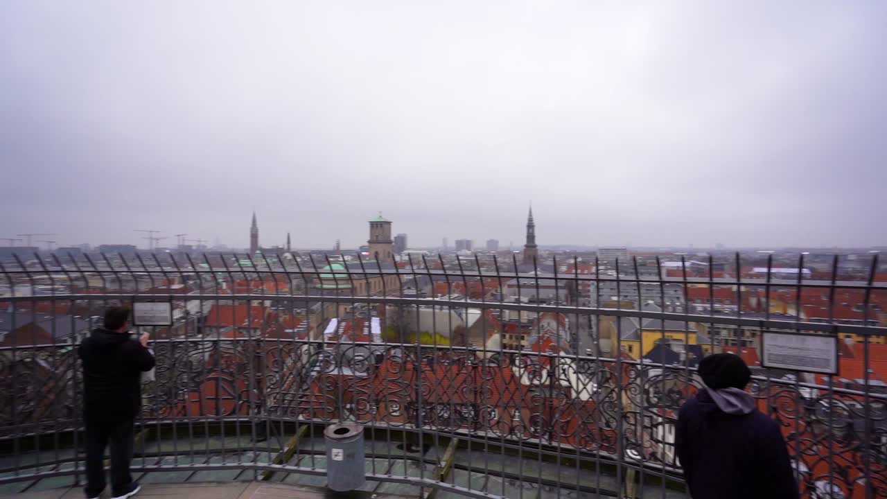 Panoramic handheld circle view of downtown Copenhagen on cloudy overcast day, Denmark, pan left