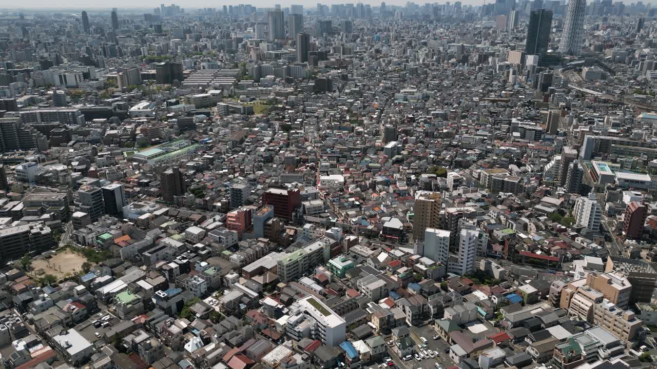 Aerial Scenic Urban Drone Footage of a neighborhood, streets and buildings in the Capital City of Tokyo, Japan on a Sunny Day