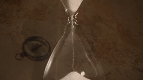 Animation-of-hourglass-over-vintage-compass-and-world-map