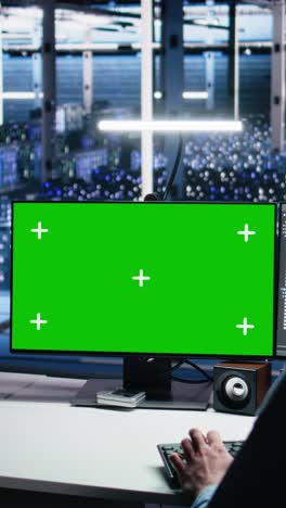 vertical video data center engineer using green screen pc to monitor neural network using ai