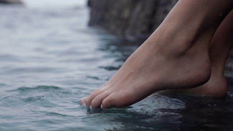 close-up-woman-feet-playing-in-water-splashing-barefoot-enjoying-calm-beach-seaside