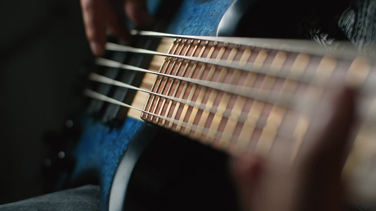 Person Playing Bass Guitar Close Up