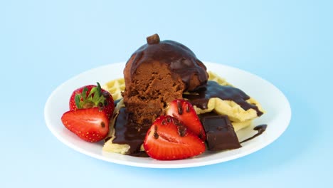 cuchara de metal tomar un pedazo de helado de chocolate en gofres con fresas