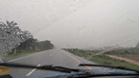 Window-Wipers-Activated-During-a-Heavy-Storm-of-Rain-While-Driving-on-a-Country-Road-in-Thailand
