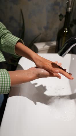 washing hands in a bathroom sink