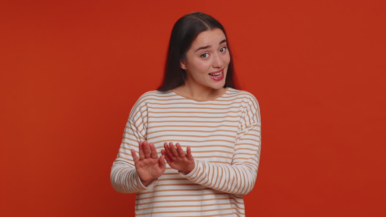 Young woman warning with admonishing finger gesture, saying no, be careful, advice to avoid danger