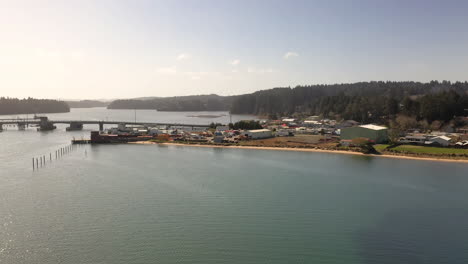 Drone-circle-view-of-bridge-and-Charleston-Marina-shoreline-in-Oregon