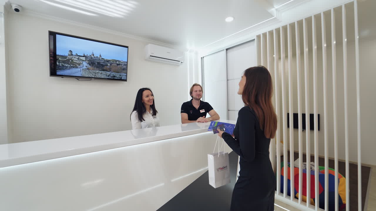 Dental clinic reception. Female patient at reception of dental clinic