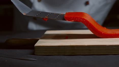cook cuts an orange jelly