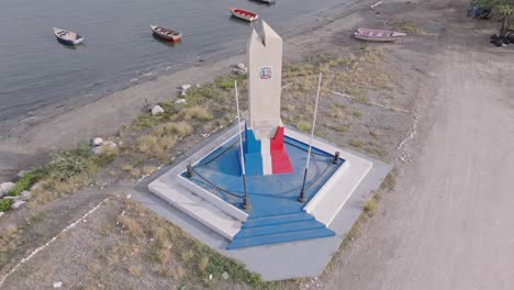 aerial top down shot of battle tortuguero monument at beach of azua during sunny day