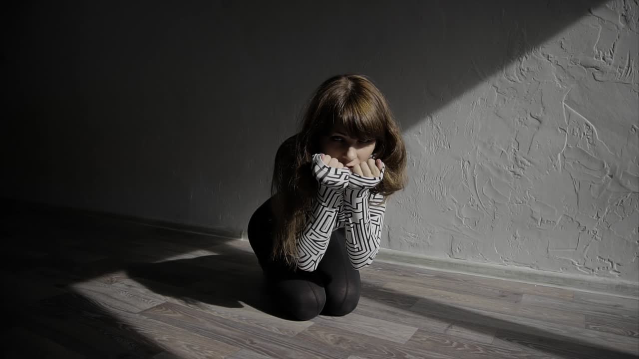 A young woman in a dark room