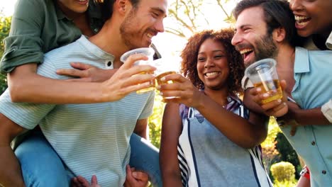 group of friends toasting a glass of beer