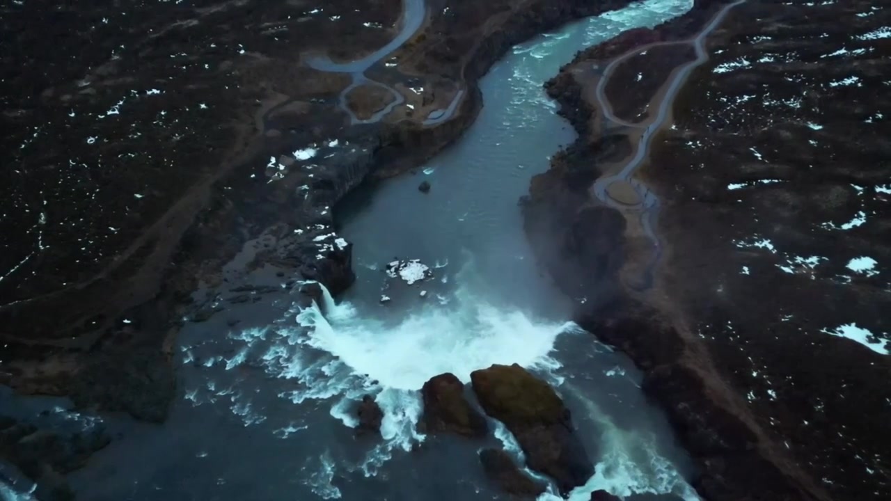 High angle aerial above Godafoss waterfall Zoom out reveal