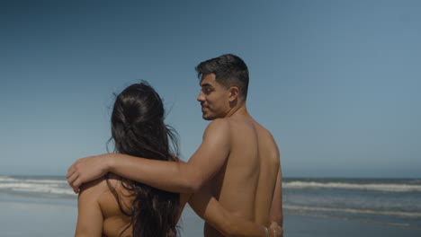 cute couple walking on the beach