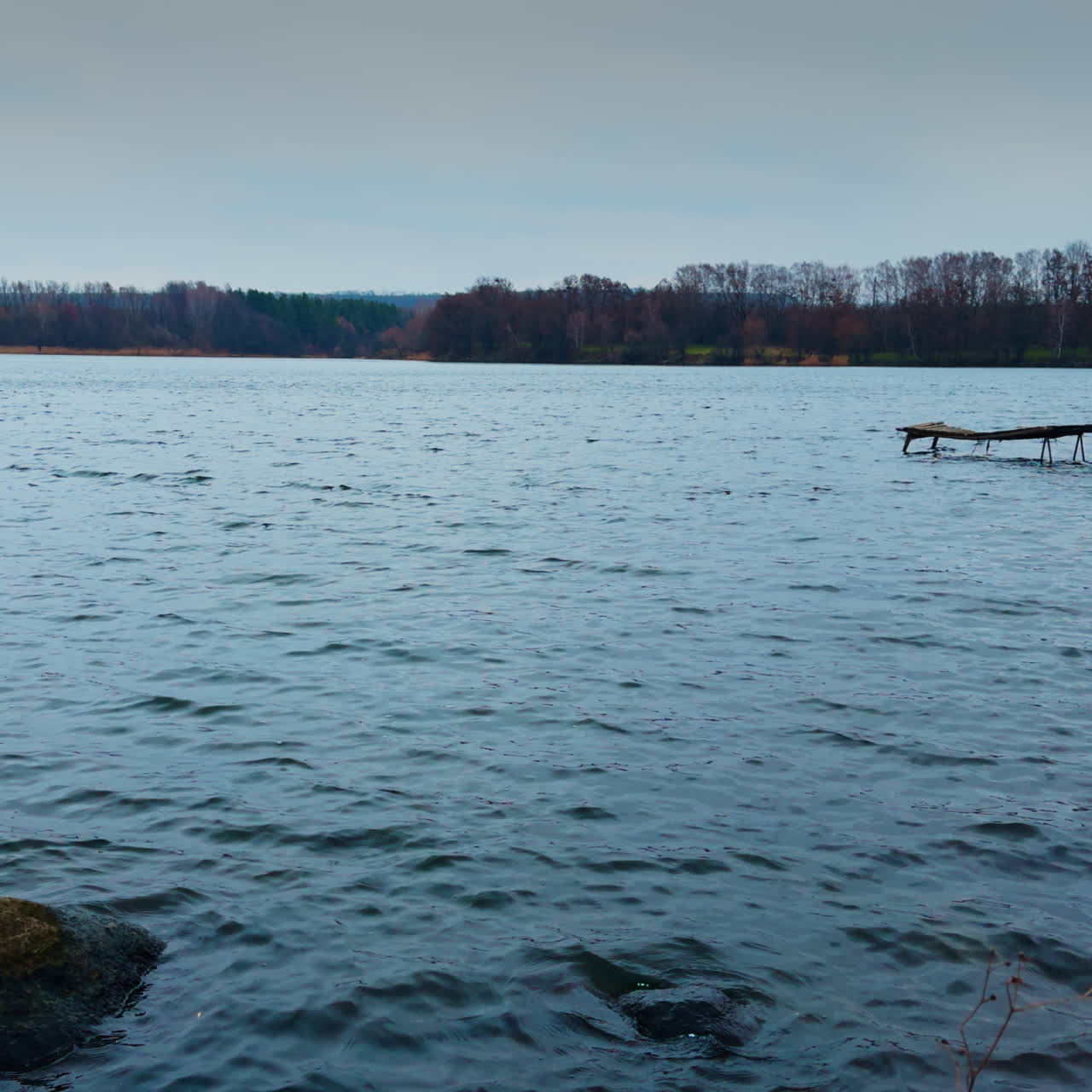 View of the river with uneven surface on winter day. Grey autumn weather in the nature.