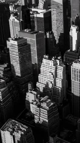 aerial view of skyscrapers in black and white, capturing urban density and shadows