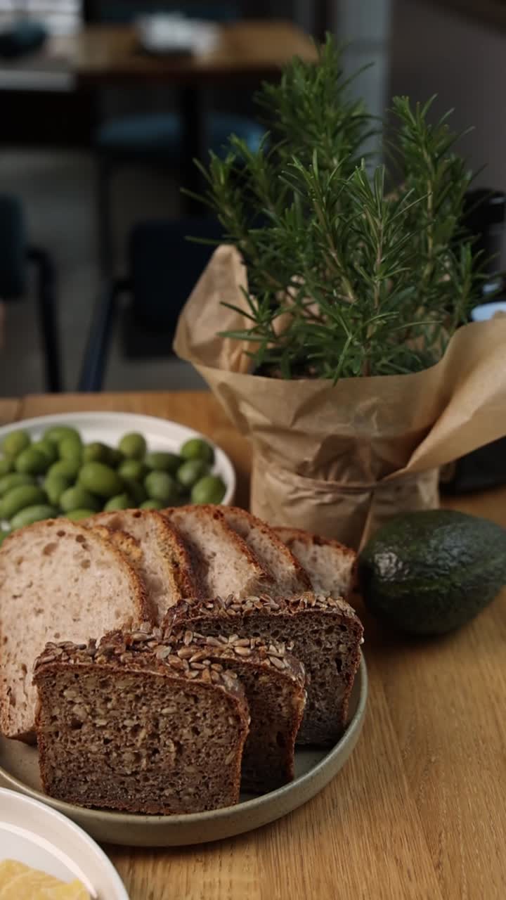 Bread, Olives, Avocado, and Rosemary Still Life