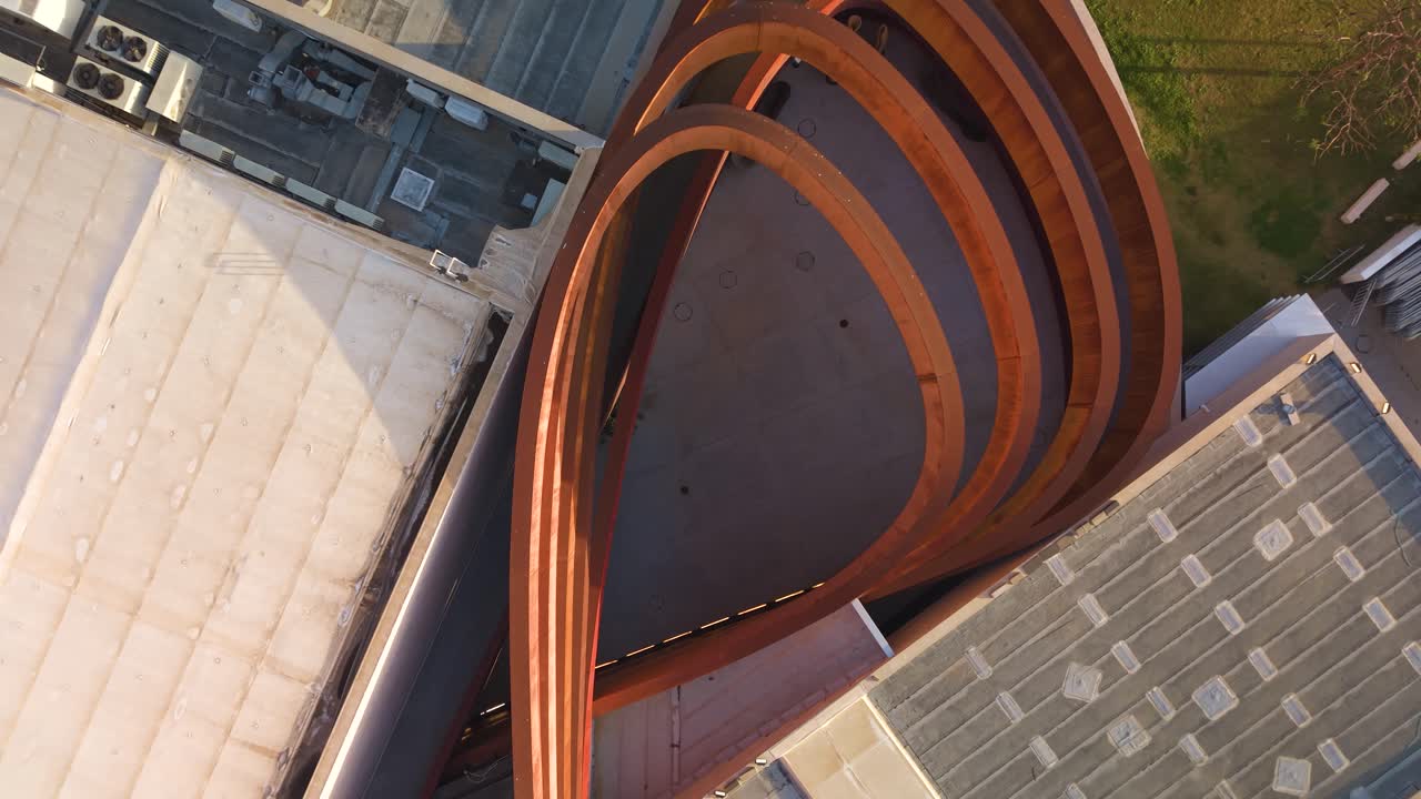 Mediatheque Design Museum's iconic red curves captured during a rising drone shot in Holon, Israel